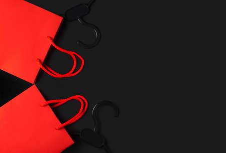 Black hanger and red bag on the black background. Black friday sale concept. Copy spaceの写真素材