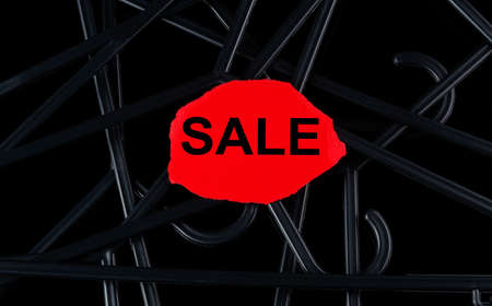 Black hangers and text SALE on the tor paper on black background. Discounts. Seasonal sale.の写真素材