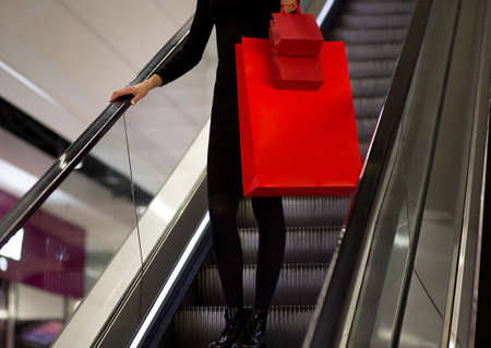 Black Friday, Woman holding red shopping bag on mall backgroundの写真素材