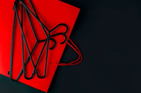 Black hanger and red bag on the black background. Black friday sale concept. Copy spaceの写真素材