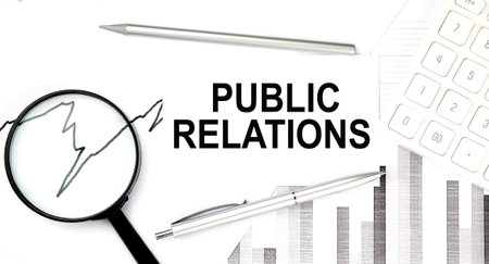 PUBLIC RELATIONS text on the document with pen, graph and magnifier, calculatorの写真素材