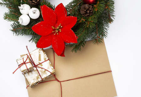 christmas wreath with red ribbon and golden decoration with envelope and gift isolated on white...