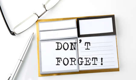 DON'T FORGET text on sticky notes with glasses and pen, businessの写真素材