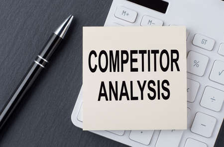 Text COMPETITOR ANALYSIS, on sticker on calculator, business concept