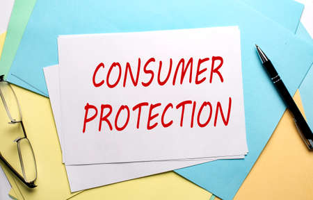 CONSUMER PROTECTION text on paper on colorful paper backgroundの写真素材