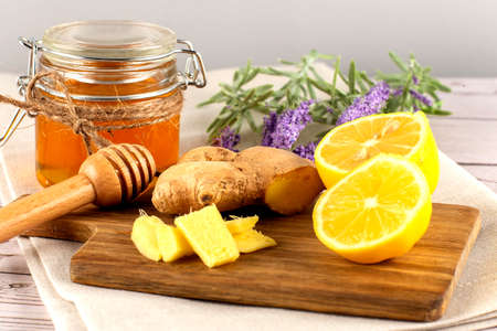 Jar of honey, lemon and ginger on the wooden backround