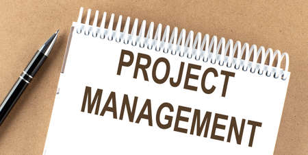 PROJECT MANAGEMENT text on notepad with pen, business