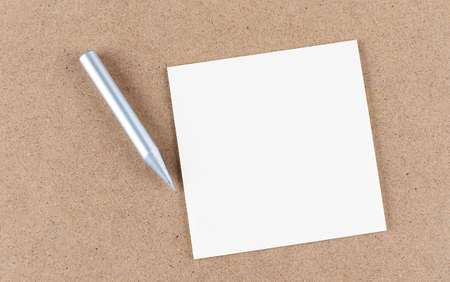 sticky note on a cork board with pencil , empty space for textの写真素材