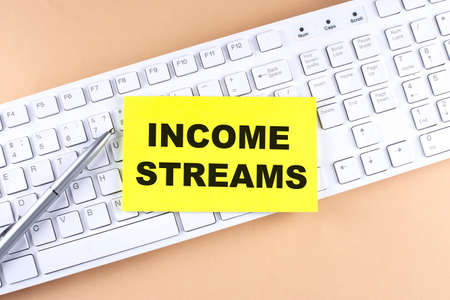 Text INCOME STREAMS text on sticky on keyboard, business conceptの写真素材