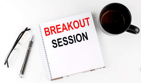 Coffee,glasses,pen and notebook written with Breakout Sessions on a white background.