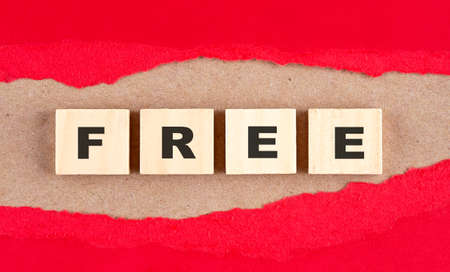 FREE word on wooden cubes on a red torn paper , financial concept backgroundの写真素材