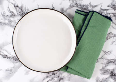 Empty ceramic plate on a light stone concrete table background. copyspace. top view.の写真素材