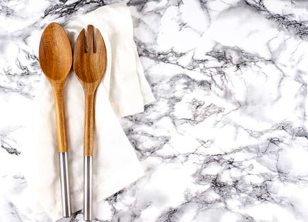Two wooden Salad Spoons on a marble Backgroundの写真素材