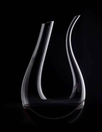 Decanter with red wine on a dark background