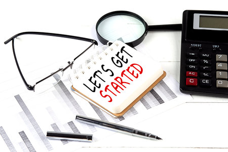 LET'S GET STARTED text on a notebook with calculator on diagram background