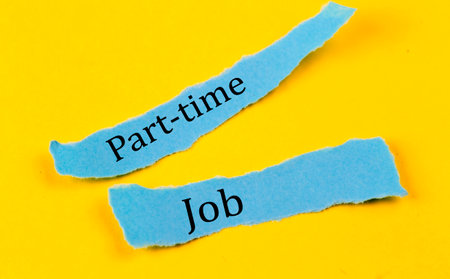 PART-TIME JOB text on blue pieces of paper on yellow background, business conceptの写真素材