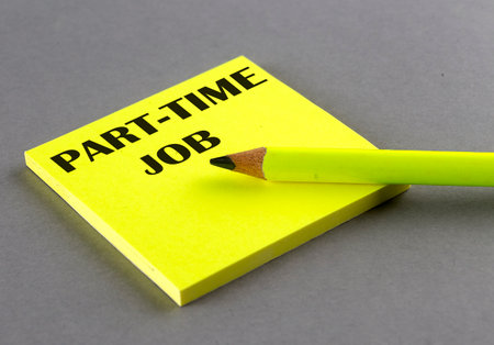 PART-TIME JOB text written on a sticky on gray backgroundの写真素材