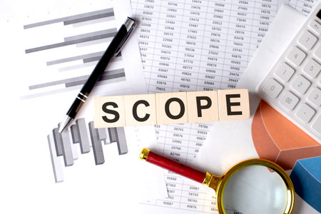 SCOPE text on a wooden block on graph background with pen and magnifierの写真素材