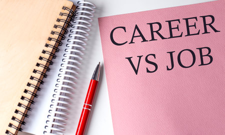 CAREER VS JOBS word on pink paper with office tools on white backgroundの写真素材