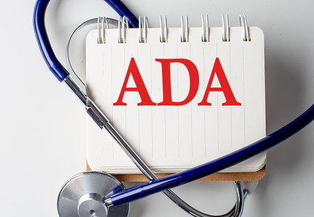 ADA word on a notebook with medical equipment on backgroundの写真素材