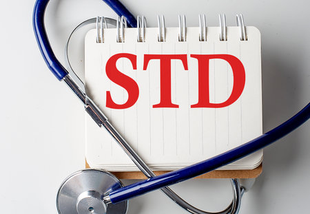 STD word on notebook with medical equipment on a backgroundの写真素材