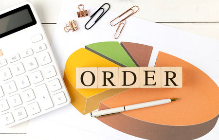 ORDER word on a wooden block on chart background.