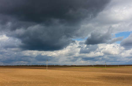 Dramatic stormy sky above rural empty fieldの写真素材