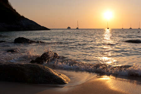 Sunset in Nai Harn cove and sailboats silhouettes. Phuket, Thailandの写真素材