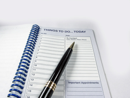Pen and appointment notebook for the appointments of today...Things to do todayの写真素材