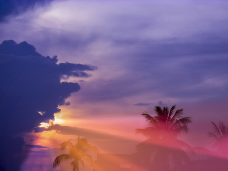 Colorful Sunset with multy colors fo blue,orange,purple,red,sunlight and Sunrays coming out to the eartの写真素材