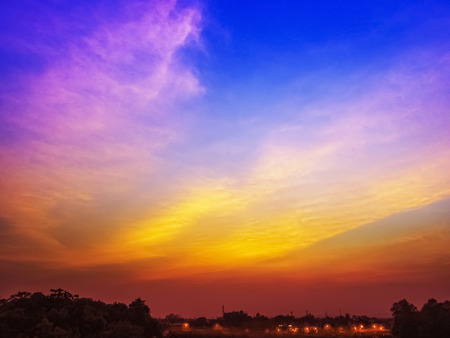 Sunset in a South Indian Tower with evening street lights on foreground -a silhouetteの写真素材