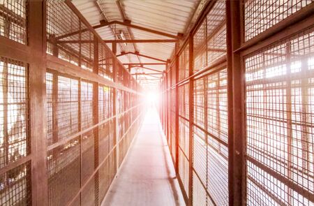 Diminishing Perspective of a Entry Gate path in the Early Evening or affternoon Sunlight at horizon.の写真素材