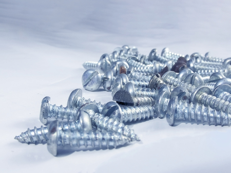 Bunch of screws in macro in the white background.の写真素材