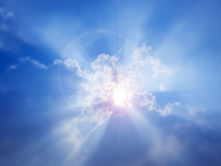 Sun glows in the laptop of cloud.In a Sunny midday Sun peeps bind the cloud - rays glowing inevery direction.concept of Purity ,freedom,etc.の写真素材