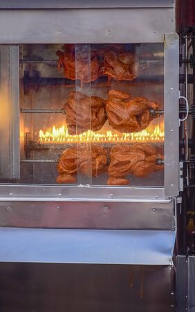 Delicious grilled chicken or Rotisserie cooking on the the grill for the travellers comming to have some food.の写真素材