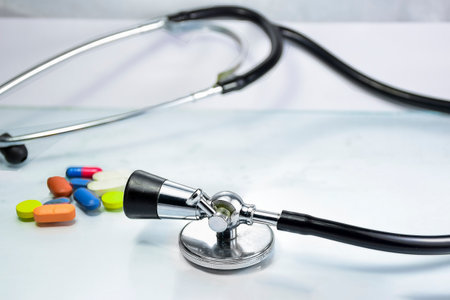 Stethoscope and pills on white background. Health care and medical concept.の写真素材