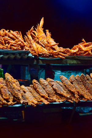 Street food made with different types of Ocean fishes, crabs, octopus ect at  the sea beach side of...