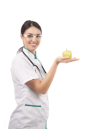 Female doctor offer an appleの写真素材