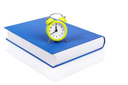 Alarm clock and bookの写真素材