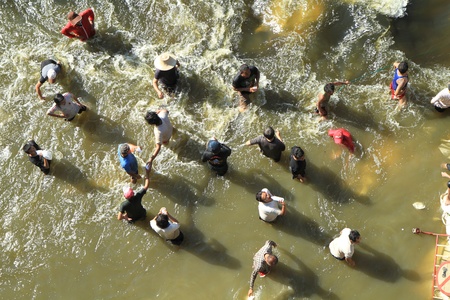 BANGKOK, THAILAND - NOVEMBER 13: Group of men destroying water barrier to open the water flow to opposite during the worst monsoon flooding in decades in Bangkok, Thailand on November 13, 2011. のeditorial素材