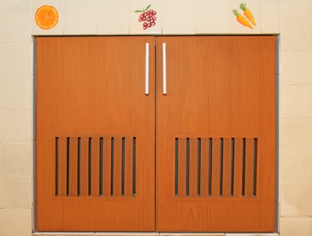 Wooden cabinet doors and handles with tiled frameの写真素材