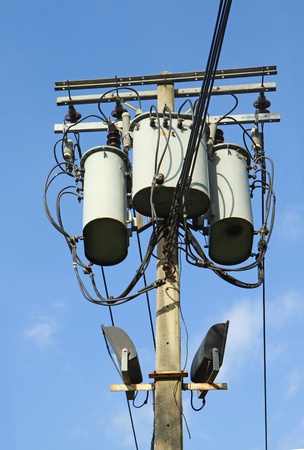 Transformers of an electrical post with powerlinesの写真素材