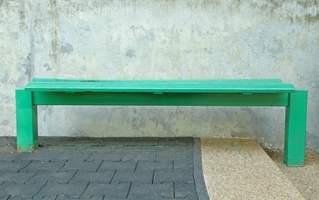 Green bench Old cement wall backgroundの写真素材