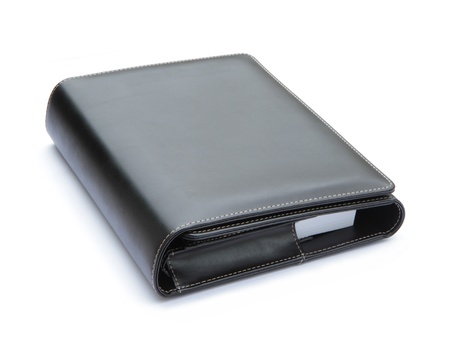 Black leather cover notebook isolated on white background の写真素材