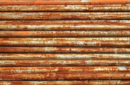 Stack of rusty metal pipes の写真素材