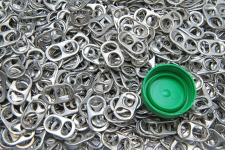 Ring pull of cans and green lid for background 