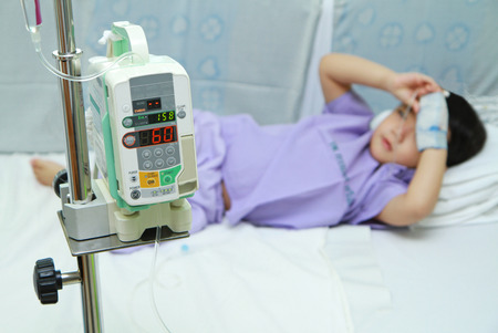 Asian children patient sleeping in hospital bedの写真素材