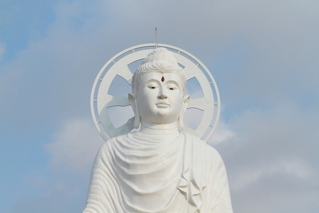 White buddha statue with blue sky backgroundの写真素材