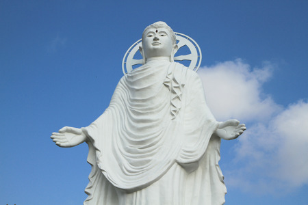 White buddha statue with blue sky backgroundの写真素材