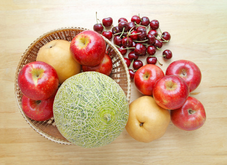 Assortment of fruits on wooden tableの写真素材